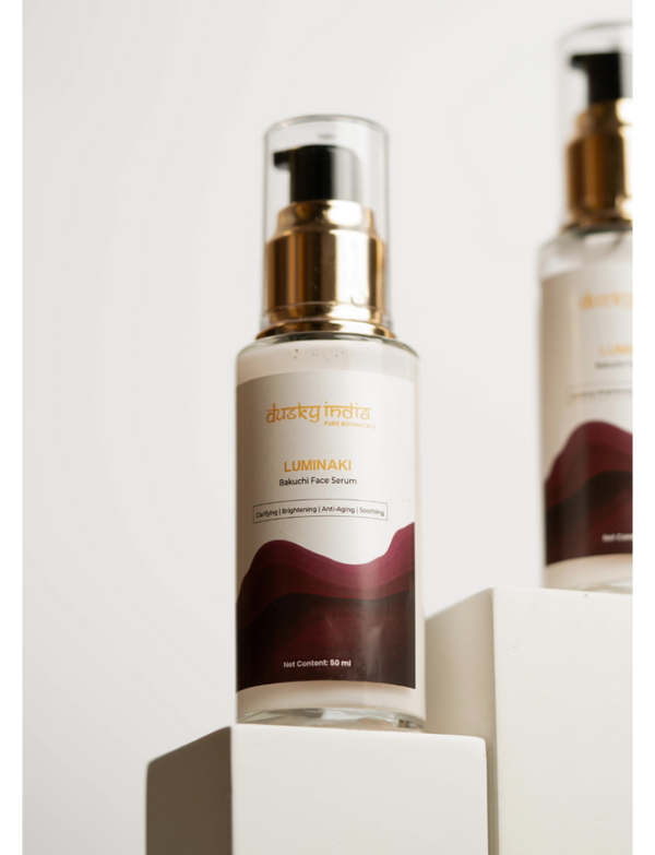 Luminaki - Bakuchi Face Serum displayed on a pedestal, showcasing its elegant packaging and branding from Dusky India.